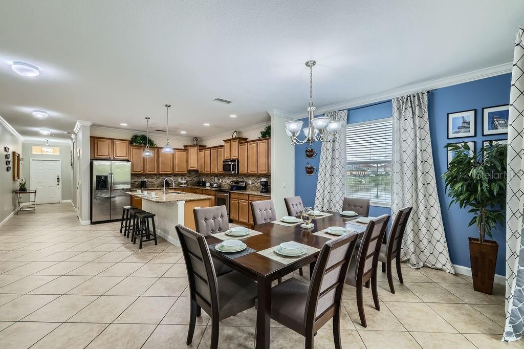 2999 Buccaneer Palm Road Kissimmee, FL 34747 - Photo 11 of 49 a dining room with furniture a chandelier and kitchen view