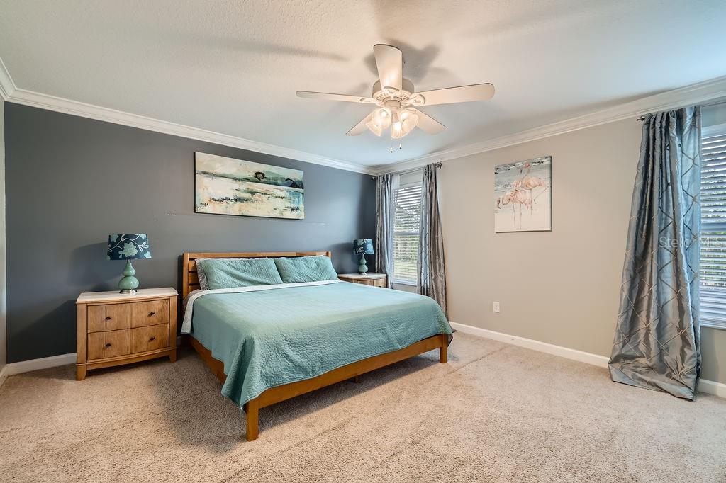 2999 Buccaneer Palm Road Kissimmee, FL 34747 - Photo 15 of 49 a spacious bedroom with a bed and a chandelier