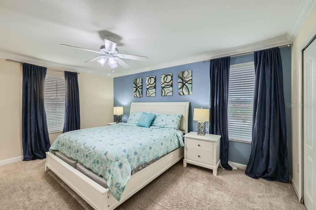 2999 Buccaneer Palm Road Kissimmee, FL 34747 - Photo 16 of 49 a bedroom with a large bed and a chandelier