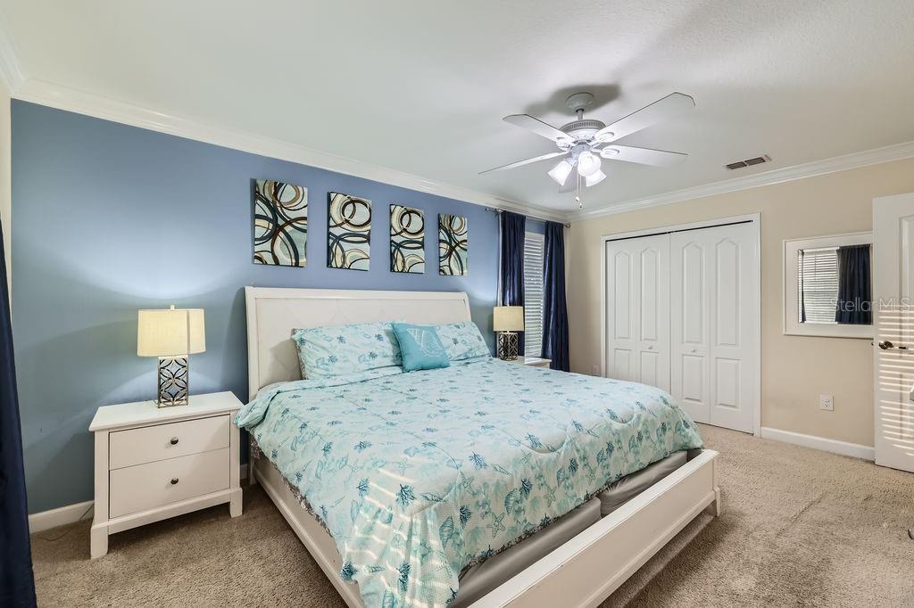 2999 Buccaneer Palm Road Kissimmee, FL 34747 - Photo 17 of 49 a bedroom with a bed and a lamp on dresser