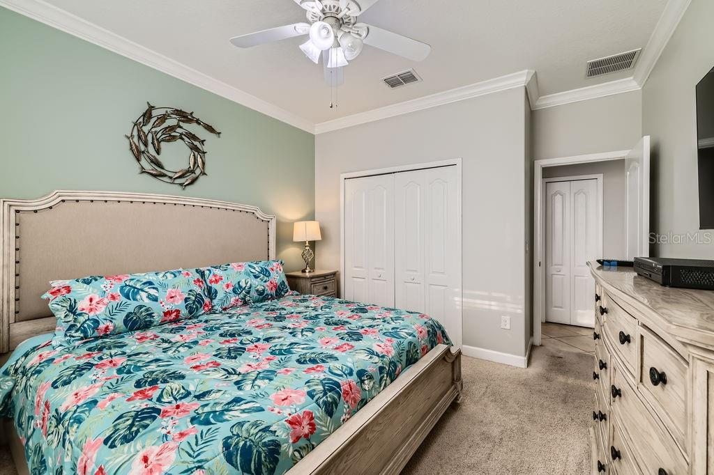 2999 Buccaneer Palm Road Kissimmee, FL 34747 - Photo 22 of 49 a bedroom with a bed and a chandelier