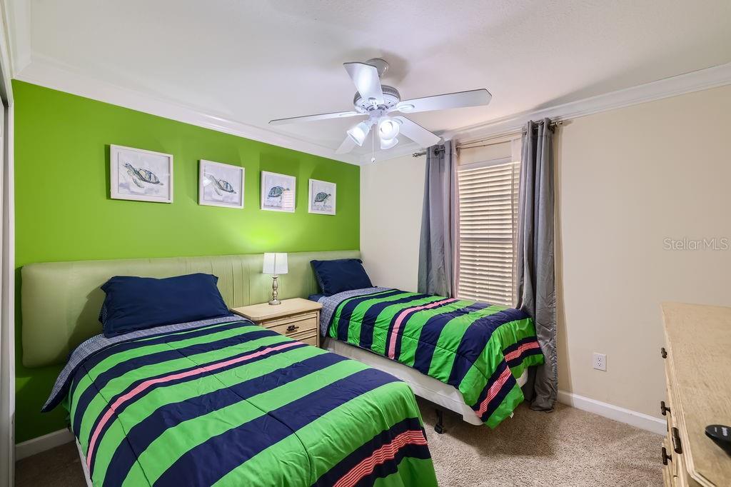 2999 Buccaneer Palm Road Kissimmee, FL 34747 - Photo 24 of 49 a bedroom with a bed and a lamp on dresser