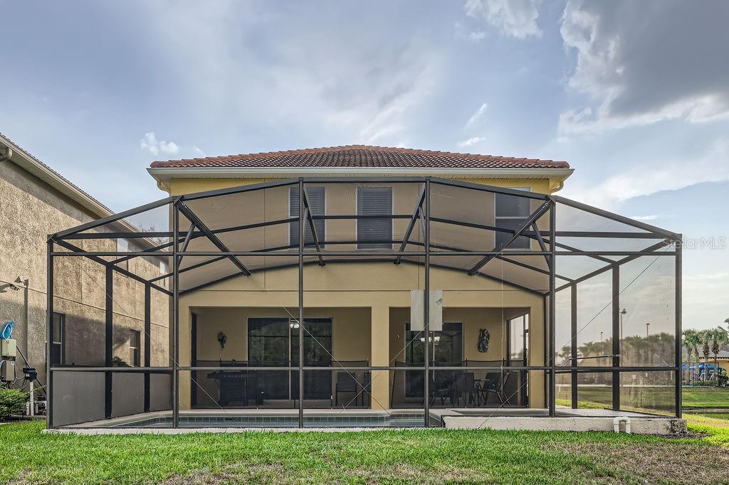 2999 Buccaneer Palm Road Kissimmee, FL 34747 - Photo 35 of 49 a view of a black and white house with a big yard and large trees