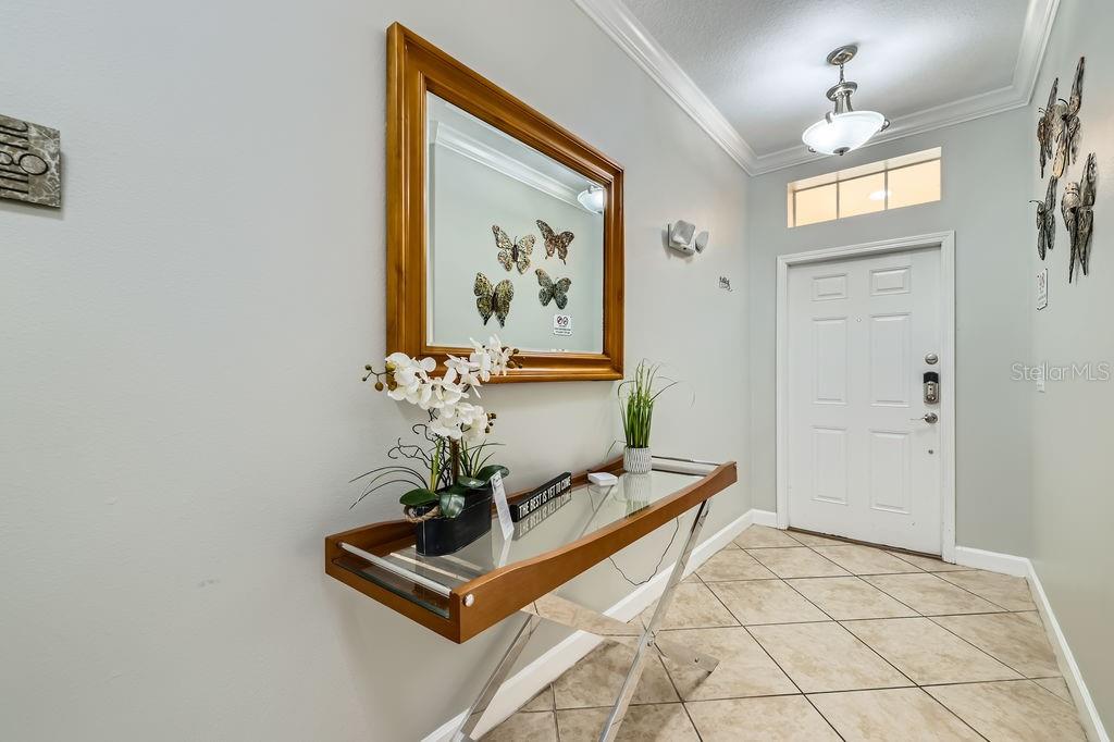 2999 Buccaneer Palm Road Kissimmee, FL 34747 - Photo 6 of 49 a view of a hallway with paintings on the wall