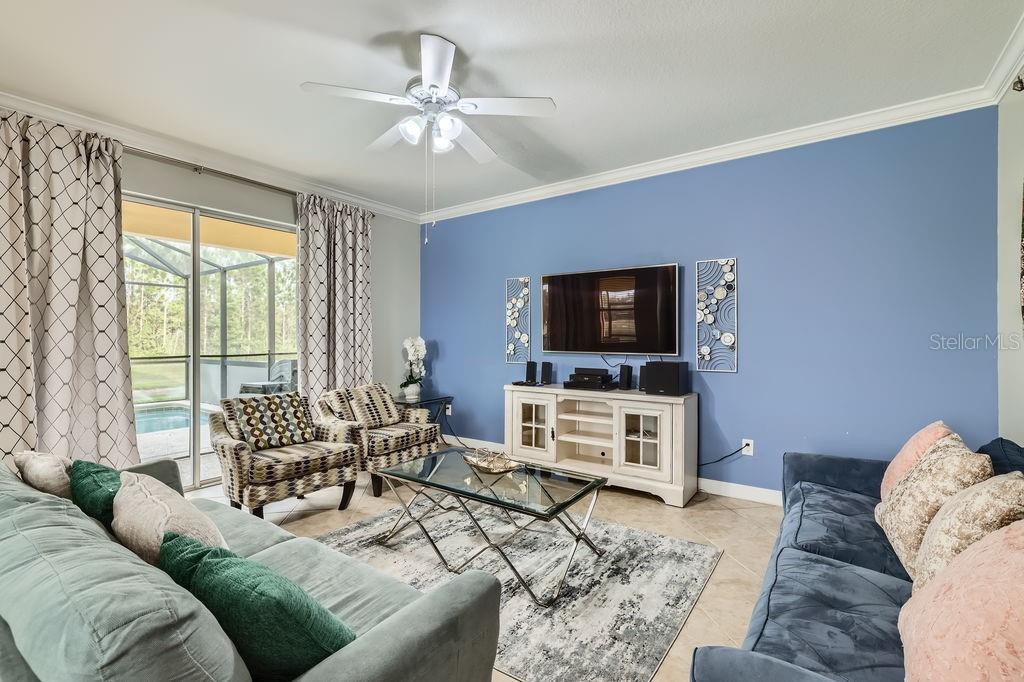 2999 Buccaneer Palm Road Kissimmee, FL 34747 - Photo 7 of 49 a living room with furniture and a flat screen tv