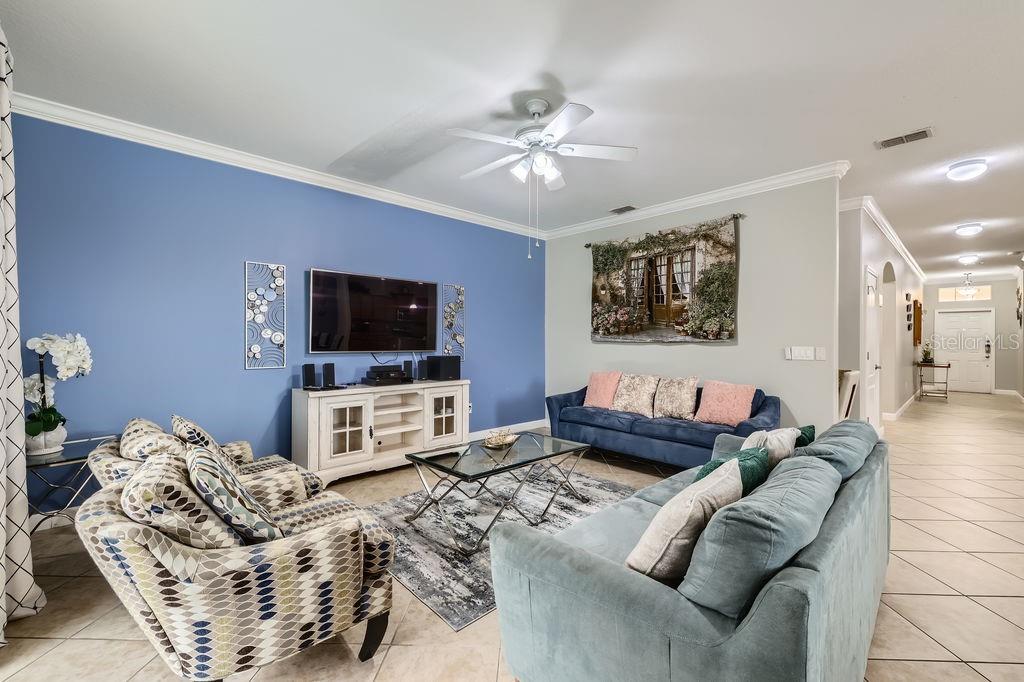 2999 Buccaneer Palm Road Kissimmee, FL 34747 - Photo 8 of 49 a living room with furniture and a flat screen tv