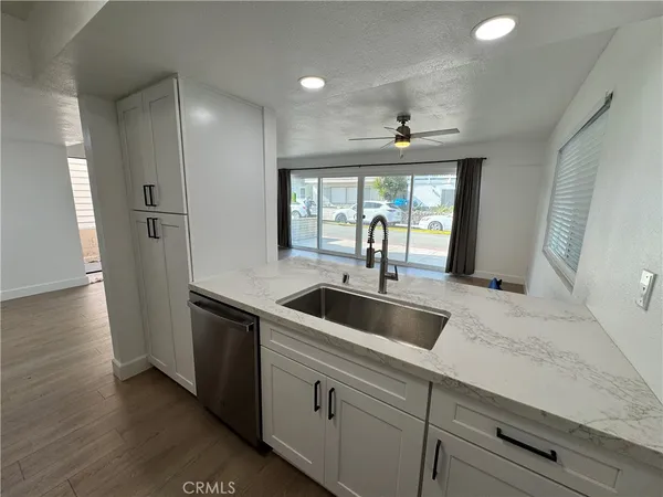 a kitchen with a refrigerator sink and cabinets