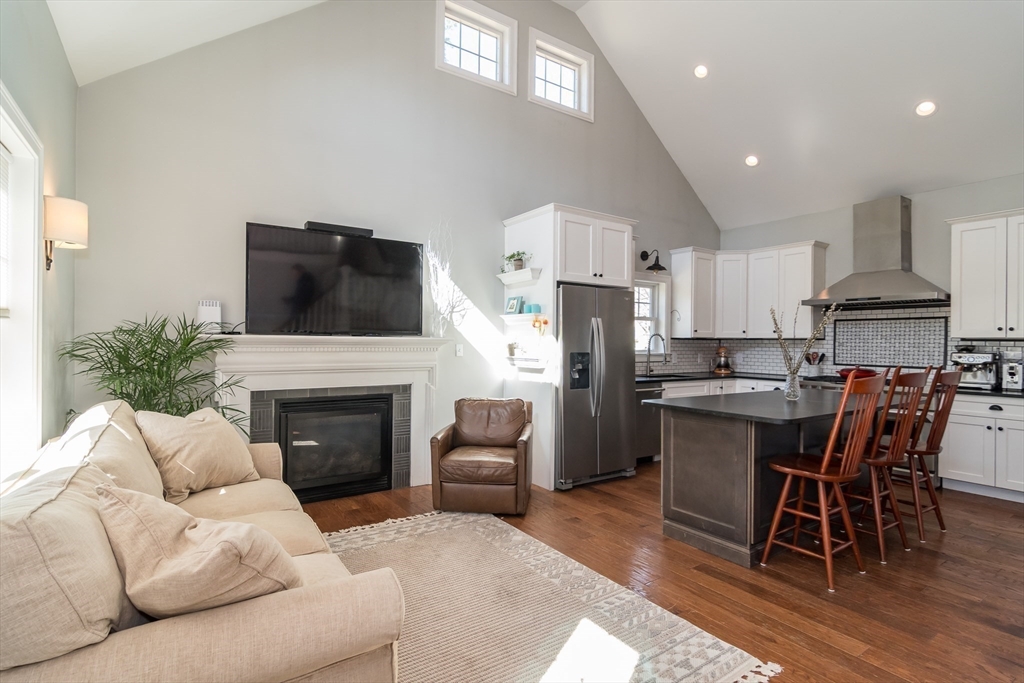 11 Durant Road Wellesley, MA 02482 - Photo 21 of 28 a living room with furniture a fireplace and a flat screen tv