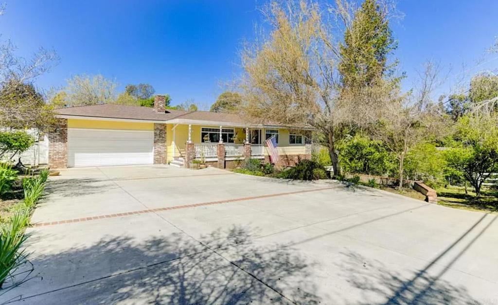 1531 McDonald Road Fallbrook, CA 92028 - Photo 1 of 1 a front view of a house with a garden and trees