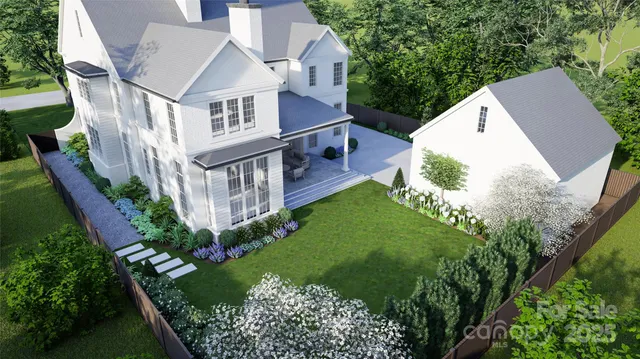 aerial view of a house with a yard and plants