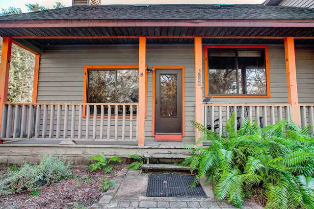 a front view of a house with a garden