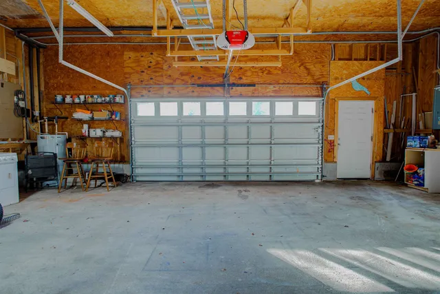 a view of a house with a yard and tree
