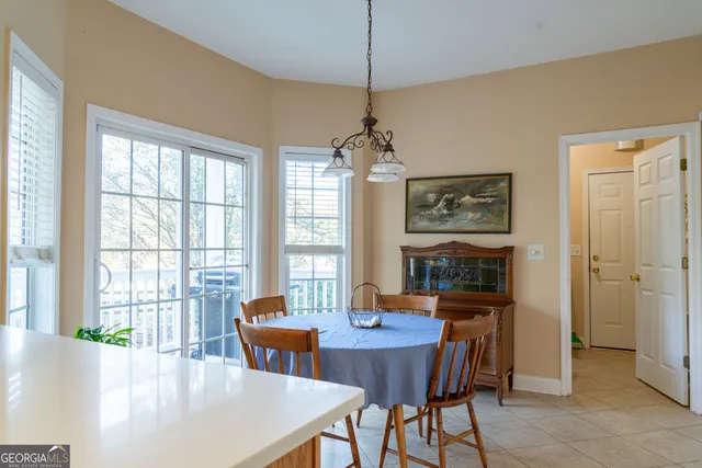 a dining room with furniture a chandelier and window
