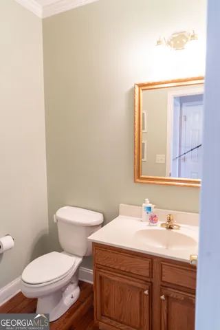 a bathroom with a sink a toilet and mirror
