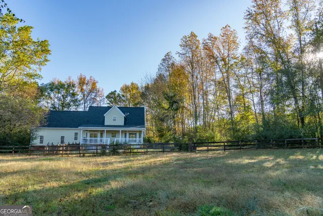 a view of a backyard with wooden floor and fence