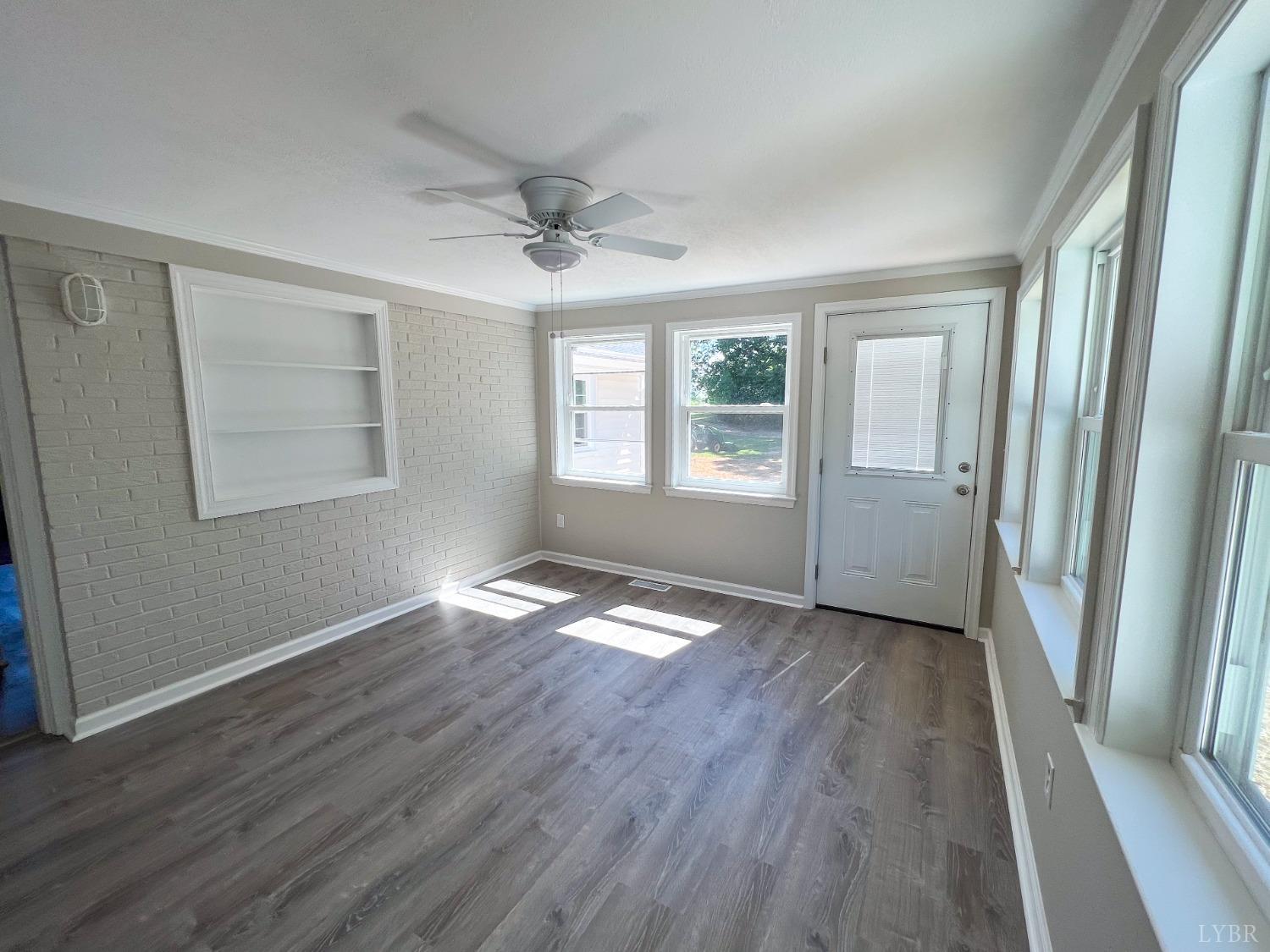 832 Dry Bridge Road Chatham, VA 24531 - Photo 21 of 27 an empty room with wooden floor and windows