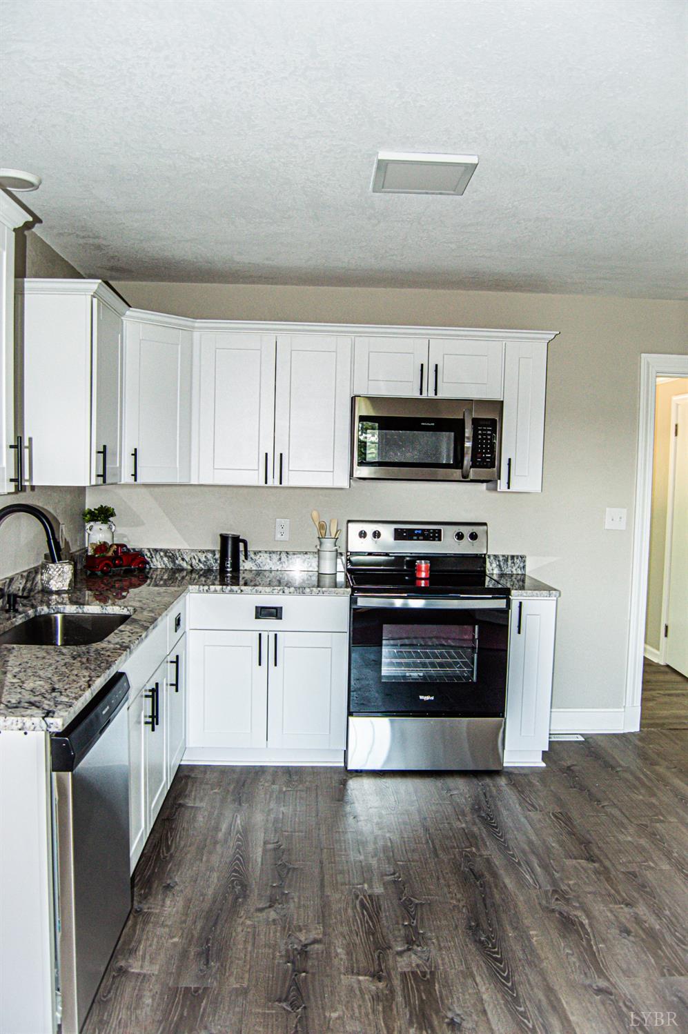 832 Dry Bridge Road Chatham, VA 24531 - Photo 4 of 27 a kitchen with sink a microwave and cabinets