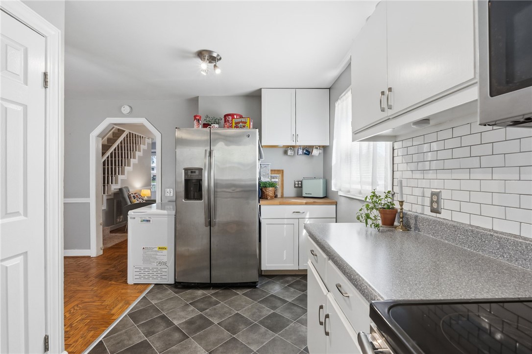 108 Tarrant Street Central, SC 29630 - Photo 18 of 42 A well-equipped kitchen features modern appliances and a tiled backsplash, offering both style and practicality.