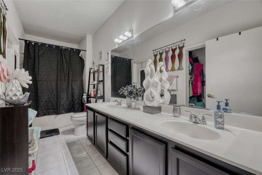8725 West Flamingo Road, Unit 134 Las Vegas, NV 89147 - Photo 14 of 24 Full bath featuring double vanity, shower / bathtub combination with curtain, and light tile patterned flooring