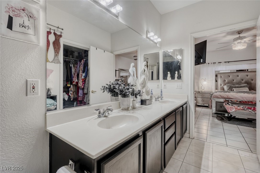 8725 West Flamingo Road, Unit 134 Las Vegas, NV 89147 - Photo 15 of 24 Ensuite bathroom with double vanity, light tile patterned floors, and a ceiling fan