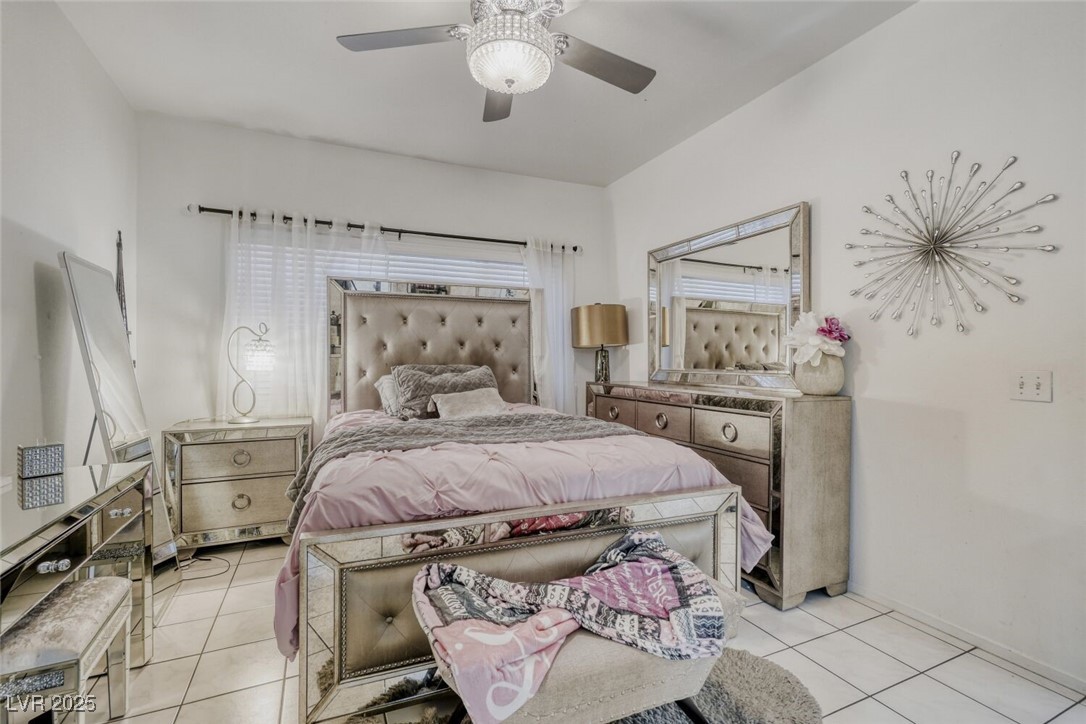 8725 West Flamingo Road, Unit 134 Las Vegas, NV 89147 - Photo 9 of 24 Bedroom featuring light tile patterned floors and a ceiling fan
