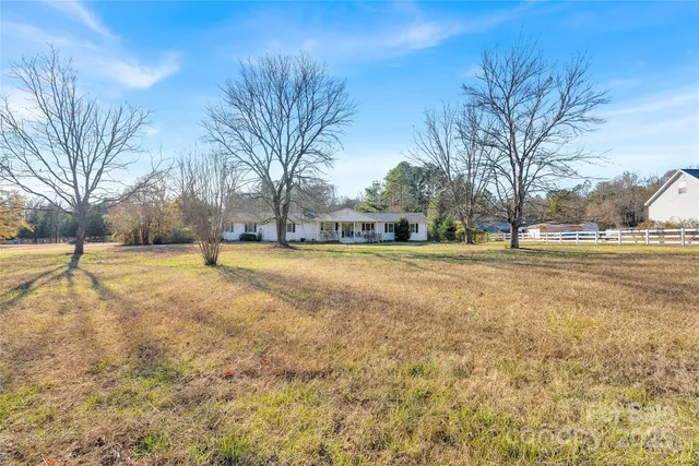 a view of a yard with swimming pool