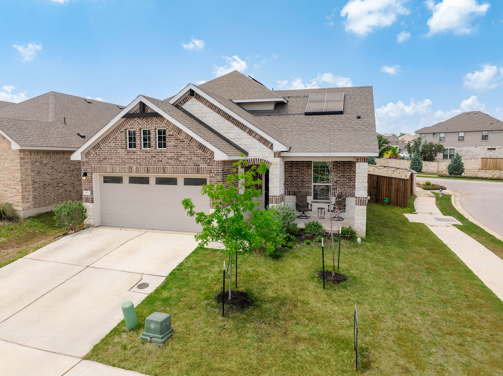 900 Balsora Cove Georgetown, TX 78628 - Photo 2 of 39 A welcoming brick and stone facade home, complete with an attached garage and inviting front porch, offers comfortable living.