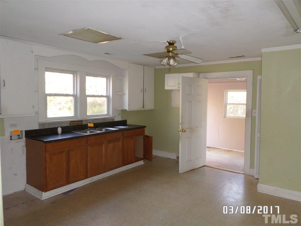 4000 Cheek Road Durham, NC 27704 - Photo 3 of 8 a view of a big room with chandelier fan and windows