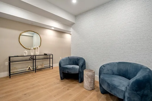 a living room with furniture and a wooden floor