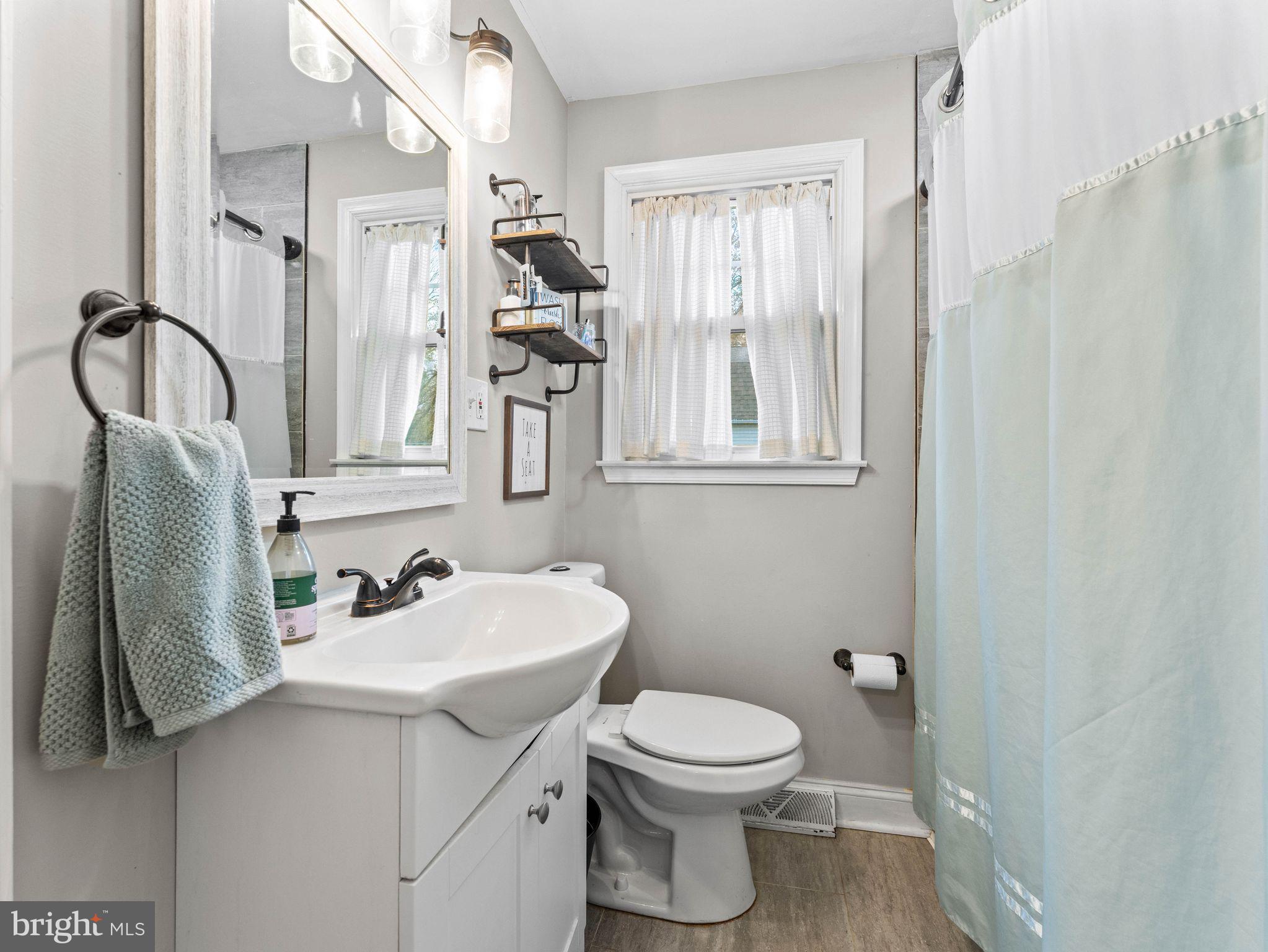 108 Estates Road Pine Hill, NJ 08021 - Photo 11 of 30 a bathroom with a sink toilet and mirror