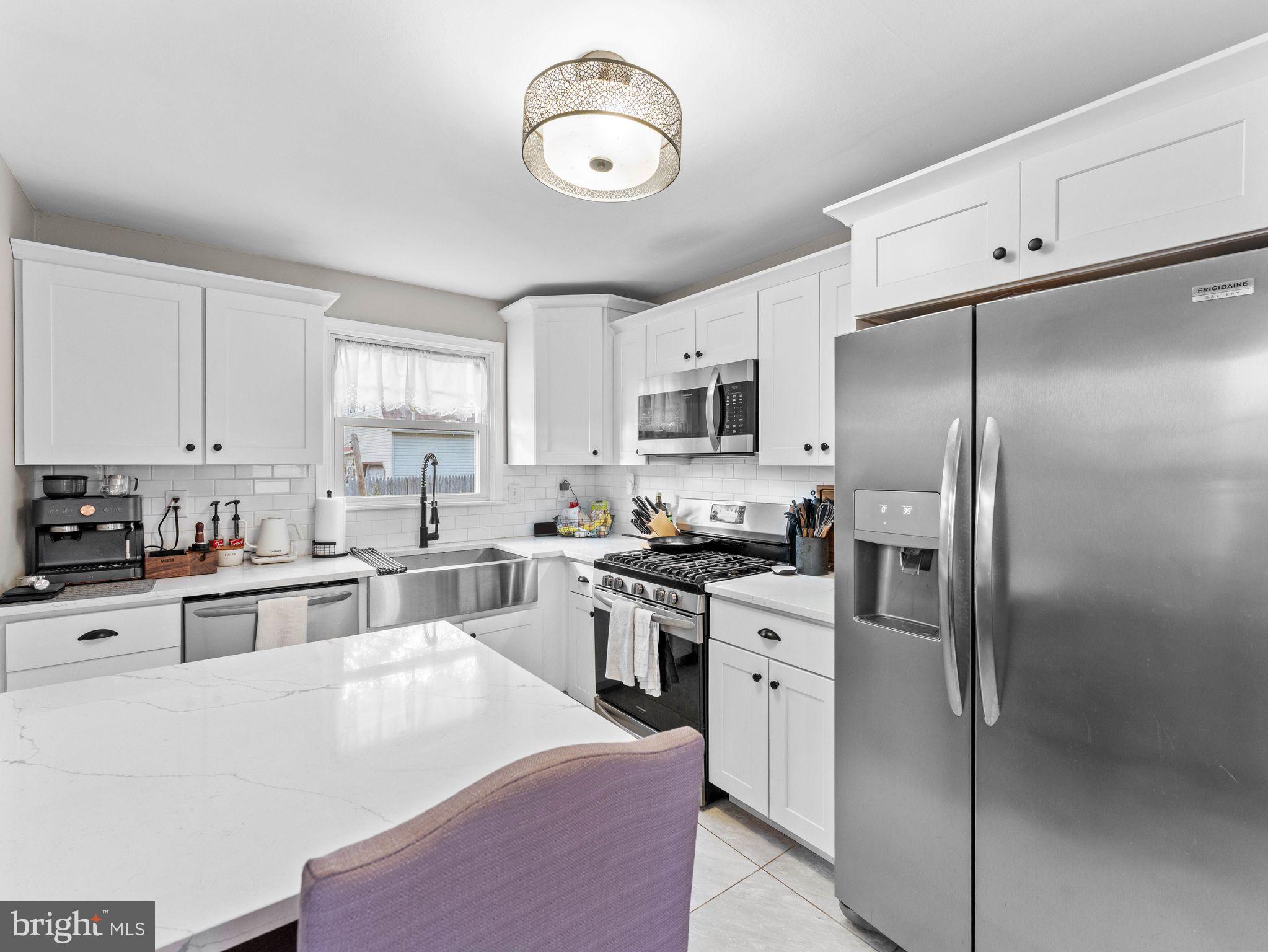 108 Estates Road Pine Hill, NJ 08021 - Photo 7 of 30 a kitchen with cabinets stainless steel appliances and a window
