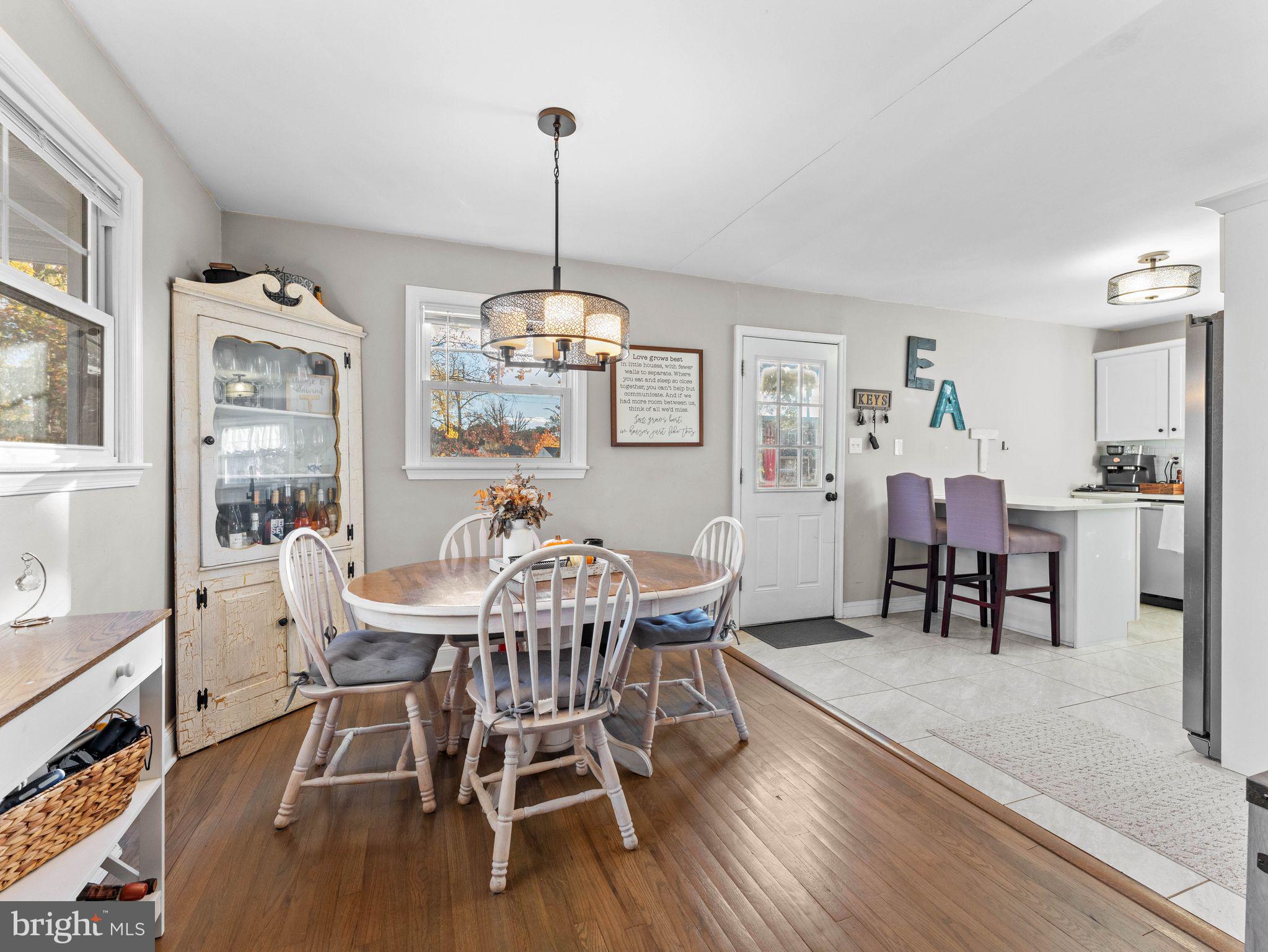 108 Estates Road Pine Hill, NJ 08021 - Photo 9 of 30 a view of a dining room with furniture a chandelier and wooden floor