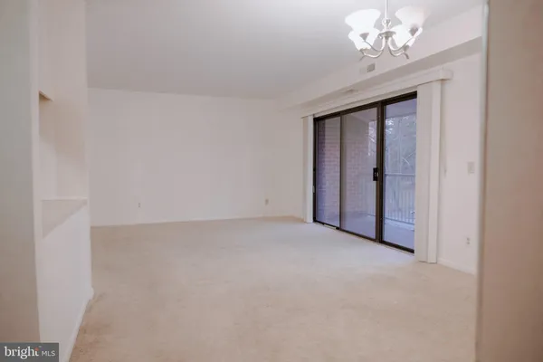 a view of kitchen with cabinets and window