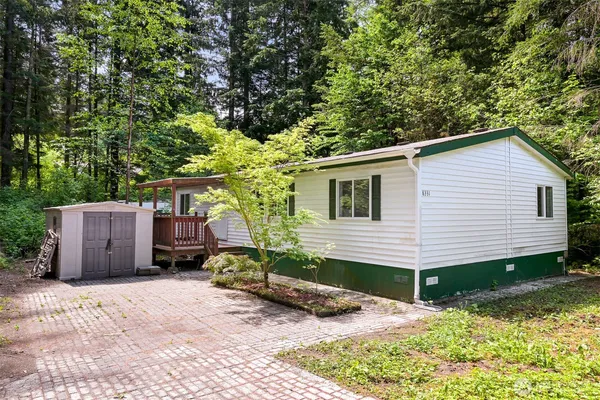 a view of a house with backyard and sitting area