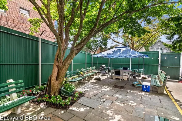a view of a chair and tables in the backyard of the house
