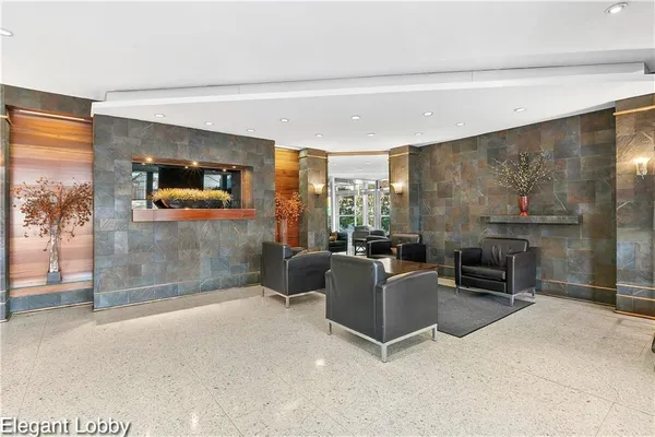 a living room with furniture a flat screen tv and a floor to ceiling window