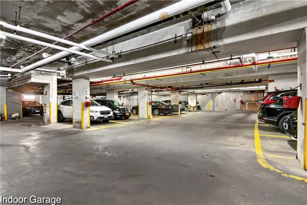 a view of parking garage with cars