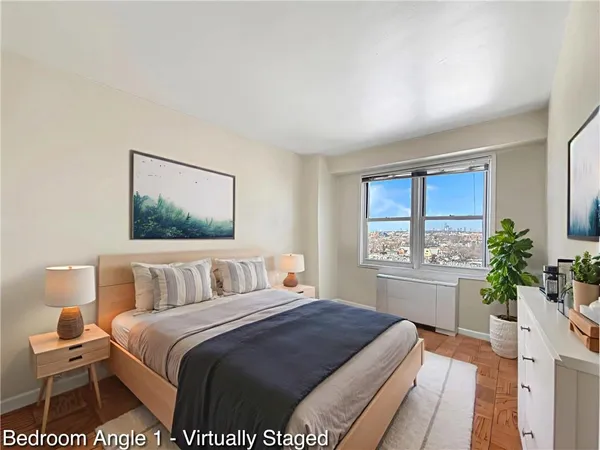 a bedroom with a large bed and a potted plant