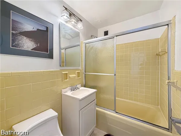 a bathroom with a shower a sink and a mirror