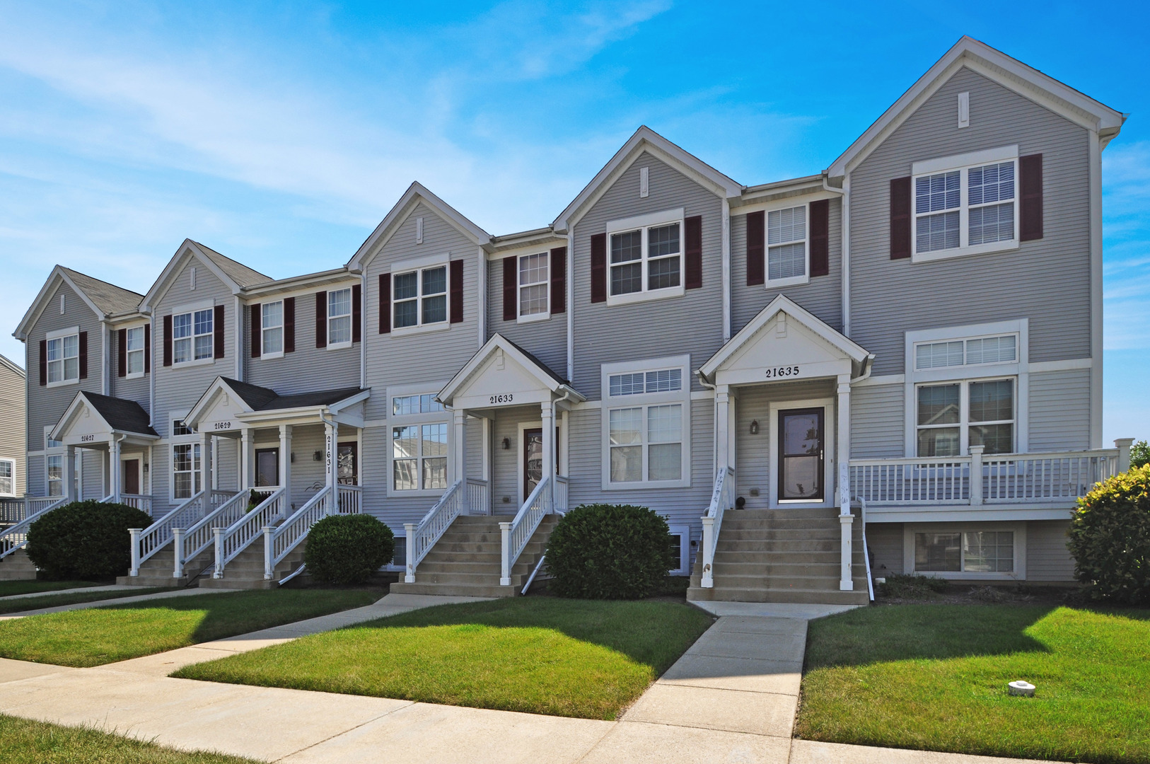 21633 Dogwood Road, Unit 1164 Matteson, IL 60443 - Photo 1 of 12 a front view of a house with a yard