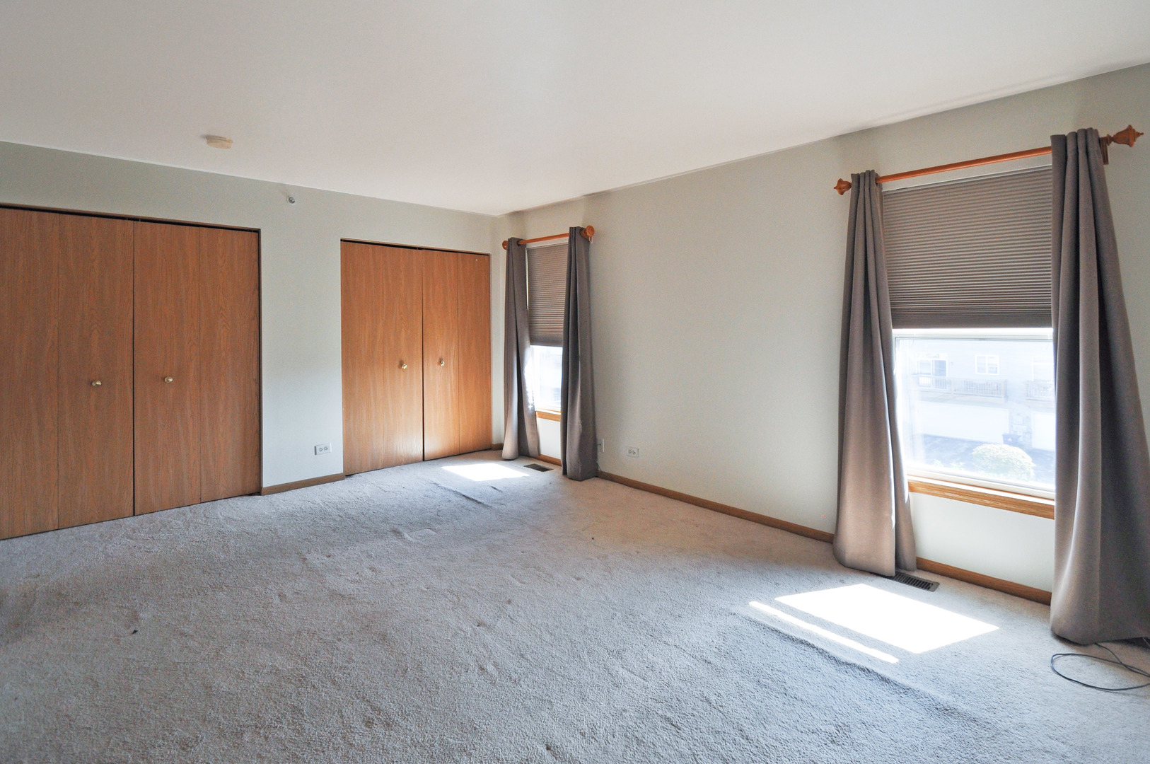 21633 Dogwood Road, Unit 1164 Matteson, IL 60443 - Photo 6 of 12 an empty room with windows and closet