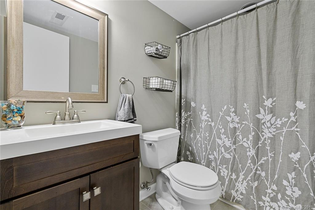 53 Old Post Road Lake Wylie, SC 29710 - Photo 26 of 36 a bathroom with a granite countertop sink toilet and a mirror