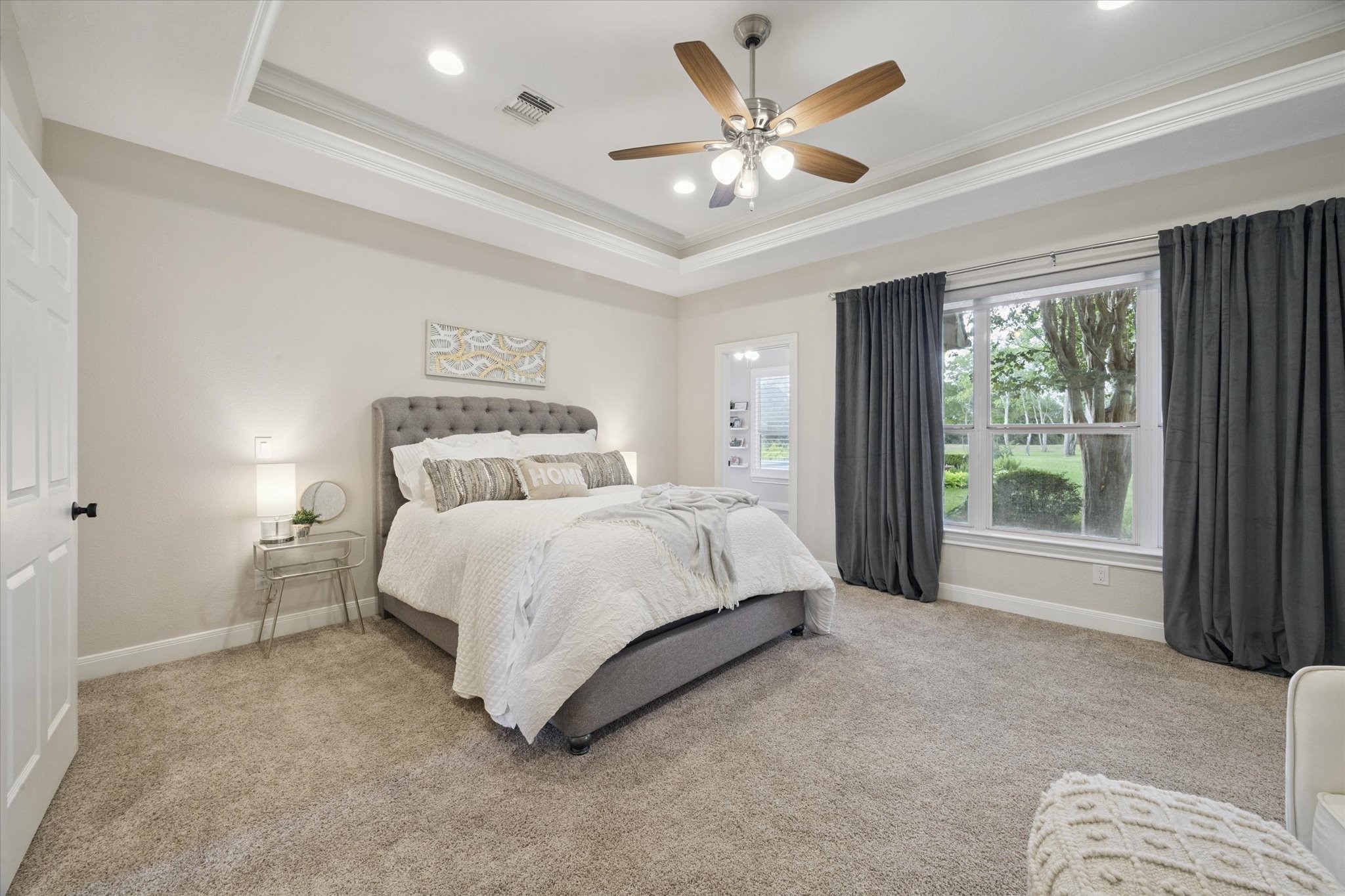 2904 Bridle Path Lane Friendswood, TX 77546 - Photo 22 of 49 The primary bedroom is spacious, timeless, and designed to offer everything you need for comfort and relaxation. The tray ceiling adds an elegant touch to the suite.