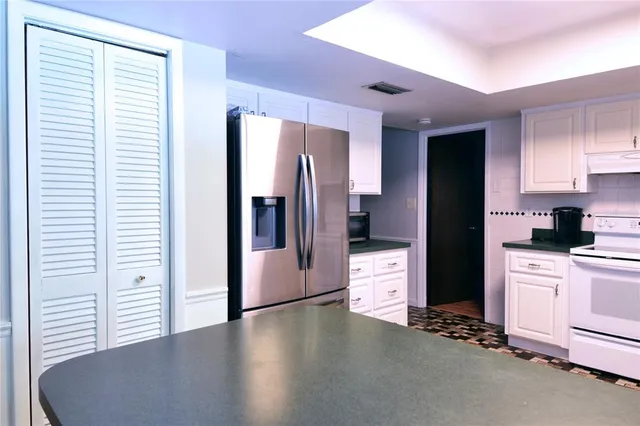 a kitchen with stainless steel appliances a refrigerator and a stove