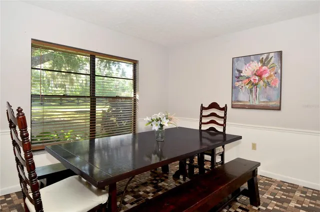 a view of a dining room with furniture window and outside view
