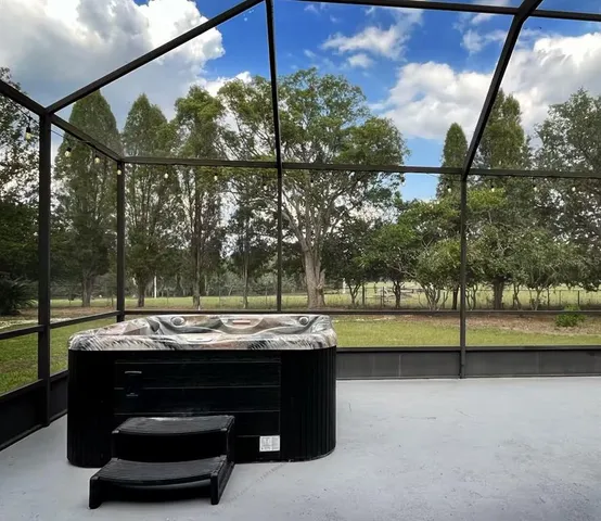 a view of sitting area in back yard of a house