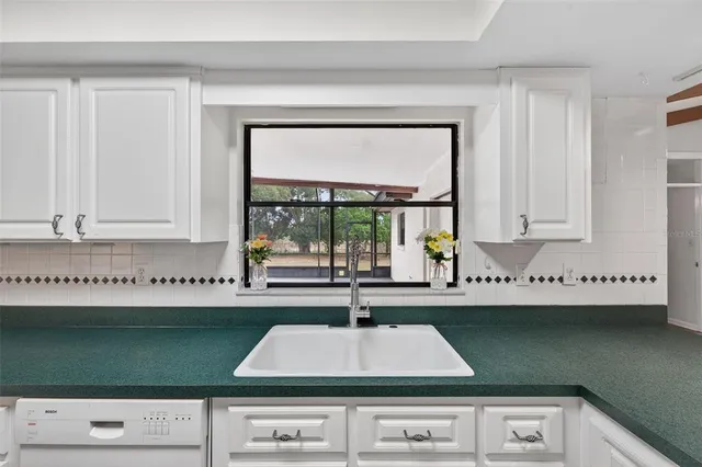 a bedroom with bed and a chandelier