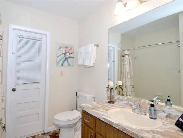 a bathroom with a sink toilet and a mirror