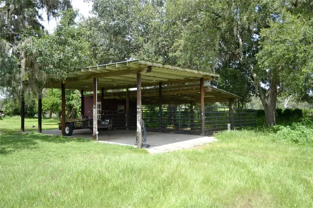 a view of a chair and table in backyard of the house