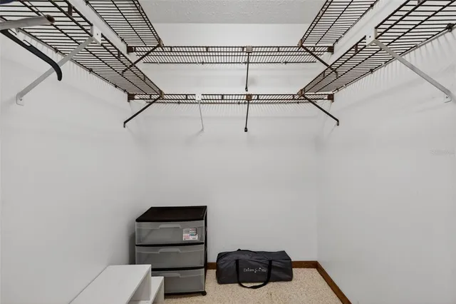 an aerial view of a house with a yard and lake view